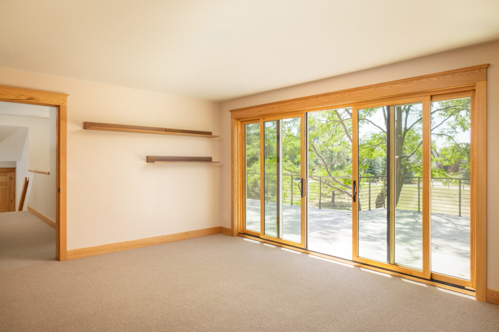 Sliding doors in the bedroom lead to the new upper deck addition, serving as a peaceful retreat overlooking the Fort Collins countryside.